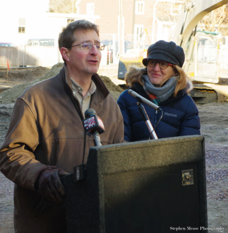 A man talking at a podium with a woman standing next to him.